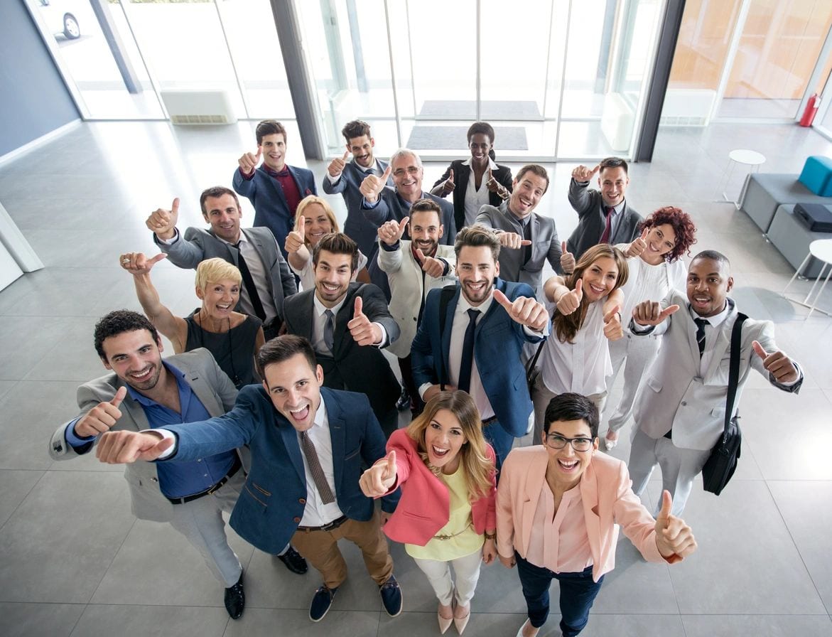 A group of people standing in an office building.