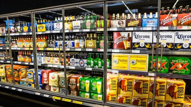 A display case filled with lots of different types of beer.